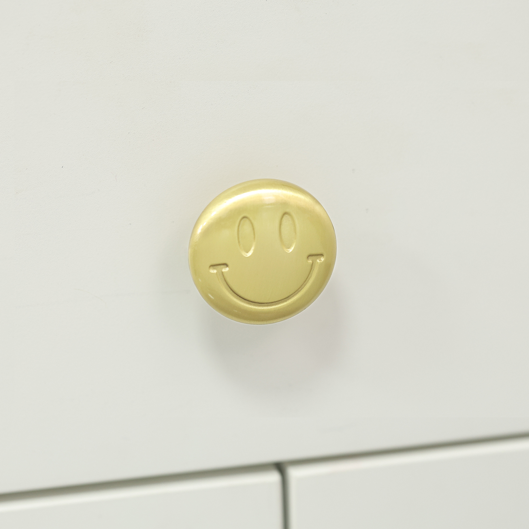 Smiley brass knob detail